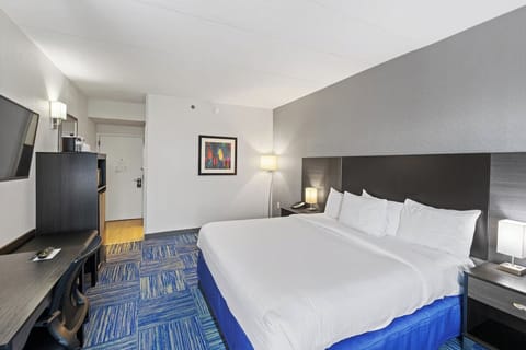 Relax in a spacious king room with cozy bedside glow.
