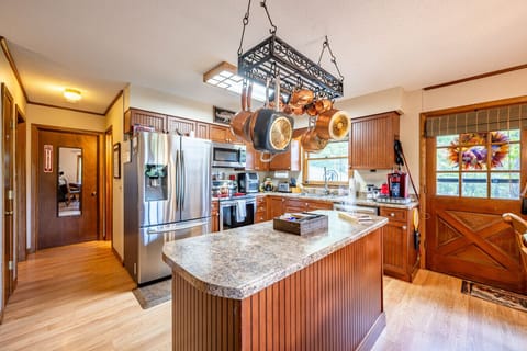 Kitchen | Fully equipped with stainless steel appliances, wood cabinetry, and ample counter space.