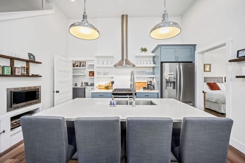 kitchen island, seating for four. Primary suite (right), laundry, pantry (left)