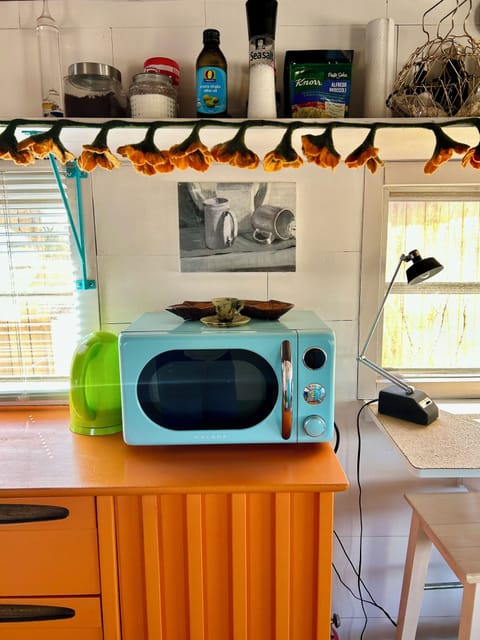 Microwave, kettle, coffee, teas, creamer, sugar and seasonings.