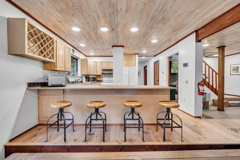 Kitchen: Main floor, drip coffee maker, French press, waffle maker, cooking utensils, tableware