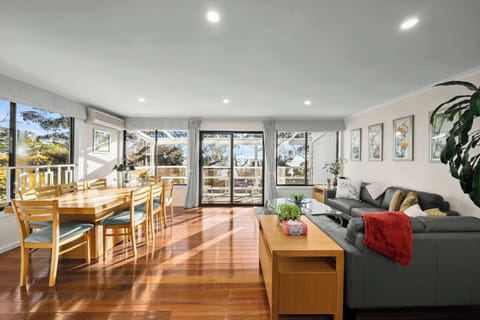 Living area with floor-to-ceiling windows allowing natural sunlight 
