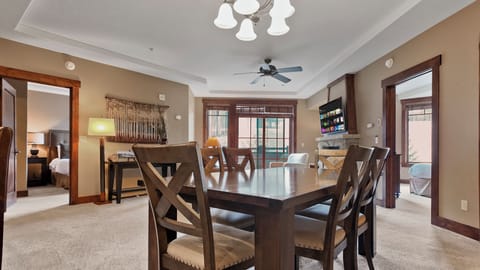 Dining area with seating for six and warm lighting.