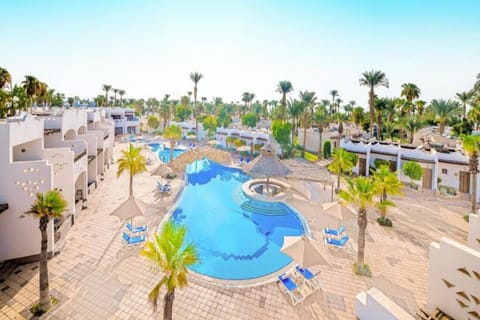 Dive into a sunlit oasis with sweeping resort views.