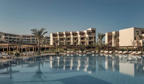 Unwind on plush loungers circling the calm, mirror-like pool.