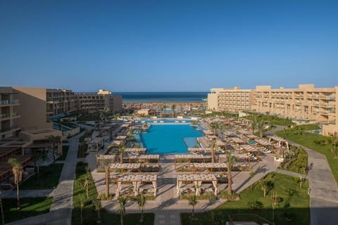 Soak up sun beside the expansive pool promenade to the beach.