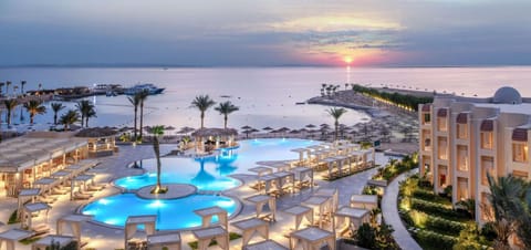 Dream at dusk as the lagoon pool lights up seaside.