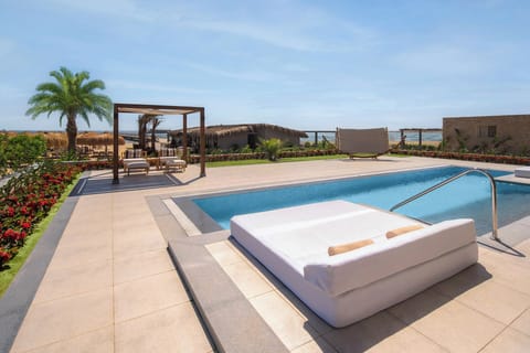 Soak up ocean breezes beside the sparkling pool and loungers.