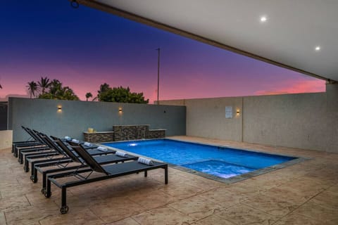 Sunset poolside with dining area and patio