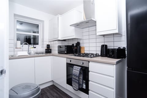 Fully equipped modern kitchen with integrated appliances, dishwasher, all utensils, cleaning essentials and complimentary tea, coffee and sugar - everything you need for a home-from-home stay.