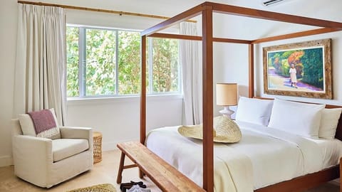 Sink into crisp linens beneath a romantic canopy bed.
