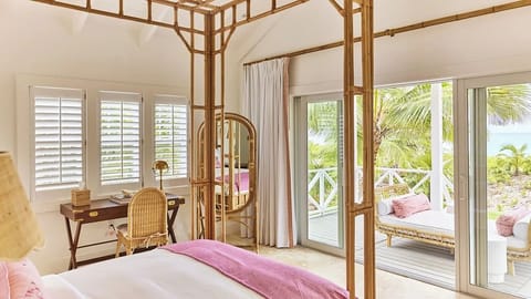 Lounge by open doors as ocean air fills the suite.