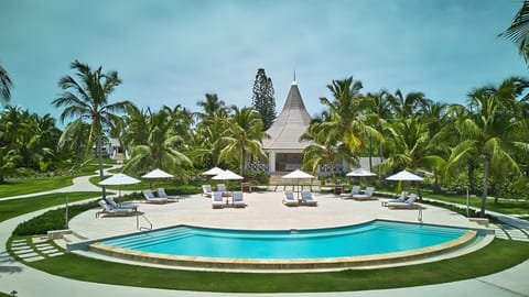 Sip something cool as the pool glows at dusk.