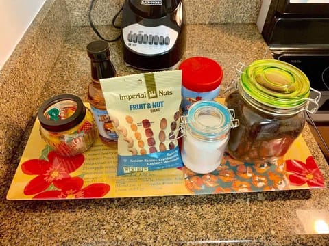 A tray with coffee, cream, sugar, snacks and candy