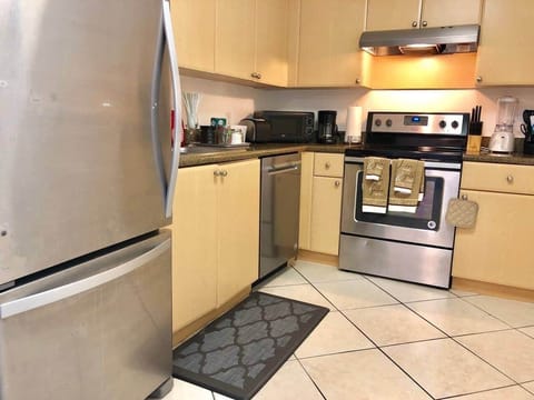 French door fridge and stainless steal appliances in a very well stocked kitchen!