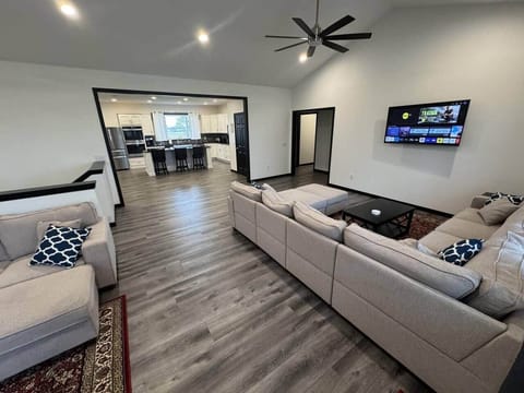 A view from the living room into the full kitchen shows the space's openness.