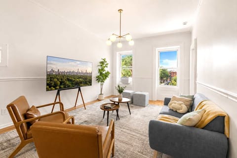 Spacious living room, comfortably seats group of people, 65-inch smart ROKU tv, overlooking the beautiful Hamilton Park in Downtown Jersey City
