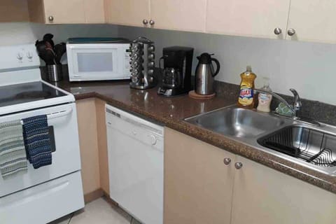 Well stock kitchen: Silverware, pots and pans, range, microwave, large freezer with ice maker, snacks, spices and more!