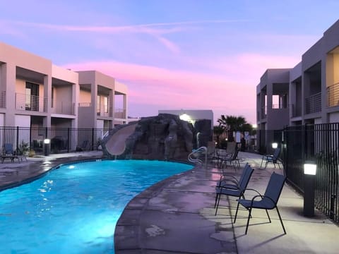 Poolside Paradise: Splash into relaxation at our stunning pool, illuminated by a colorful sunset!