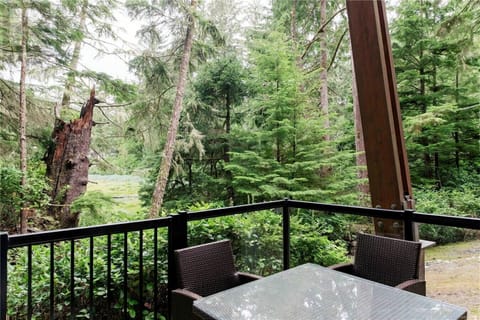 Outdoor dining patio surrounded by forest – enjoy your morning coffee or evening BBQ.