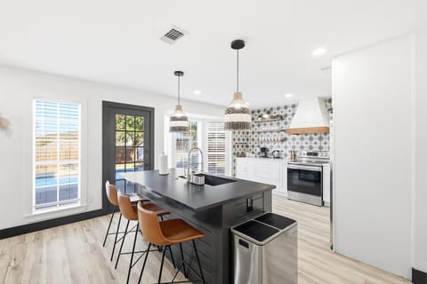 Featuring stainless steel appliances, sleek quartz countertops, and a grand kitchen island, what more could you ask for in a kitchen?
