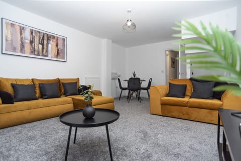 Bright living room with two standout, stylish sofas — one doubling as a comfortable sofa bed for flexible, premium extra sleeping space.