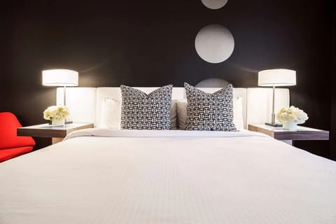 Sink into crisp linens beneath bold, modern wall art.