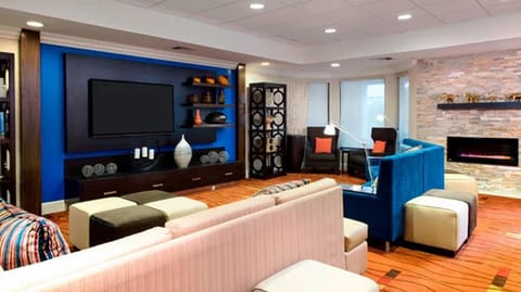 Unwind on plush seating beside a cozy, modern fireplace.