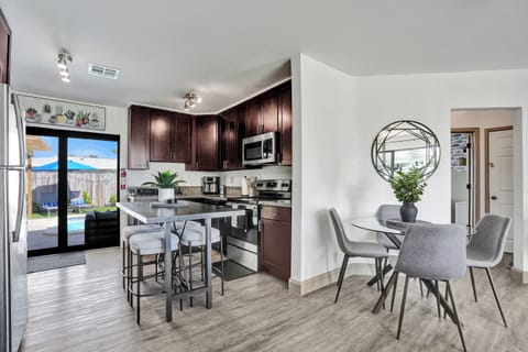 Bright kitchen with island and dining for four—open and inviting.

