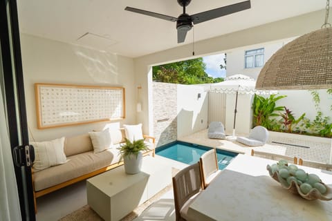 Outdoor seating and dining area overlooking the pool