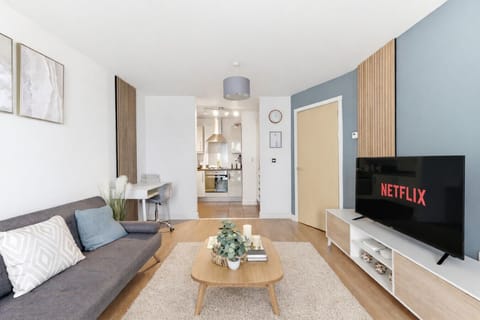 A bright and spacious living room featuring comfortable seating and a 50” TV, perfect for relaxing and unwinding during your stay