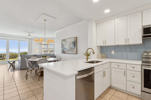 Luxury Completely Remodeled Kitchen with Stainless Steel Appliances, Stunning White Cabinetry, Quartz Countertops, a Shiplapped Island, and a Trendy Backsplash