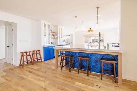 Recessed can lighting throughout, complemented by ample additional light fixtures about the kitchen counters