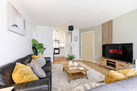 Unwind in the cosy living room, featuring two comfy sofas and a 55” Smart TV with Netflix included for your entertainment.