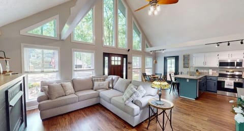 Living area with comfortable couch, smart TV, and gas fireplace.