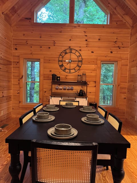 Dining area with coffee/wine bar, large windows and tall ceilings. 