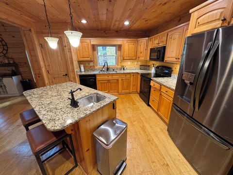 Kitchen with dishwasher, disposal, air fryer, refrigerator, stove and microwave