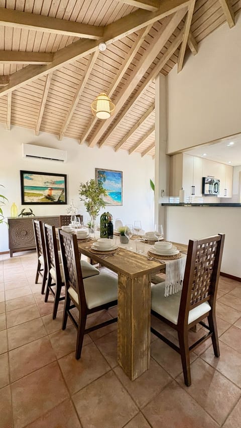 Teak dining set seats 8, is in the centre of the home & filled with sunlight