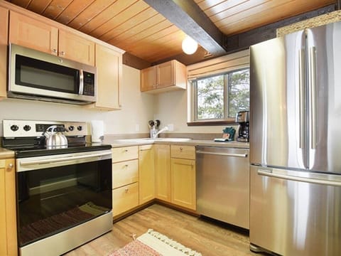 Our open-concept kitchen is fully stocked with everything you need for a home-cooked family meal—from pots and pans to a crockpot, blender, spice rack, and kid-friendly essentials.