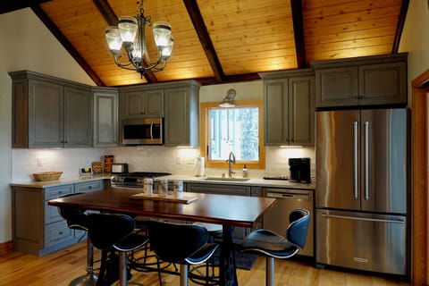 Kitchen with 6 seat table, premium cookware, flatware, accessories, and tools