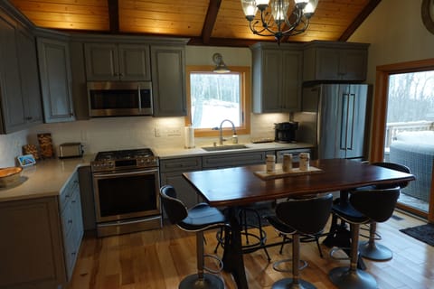 Kitchen with 6 seat table, premium cookware, flatware, accessories, and tools