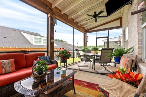 Exceptional screened porch with TV, dining area, and lounge seating.
