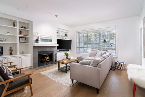 Cozy living area with fireplace, Smart TV, and patio access to hot tub and views.
