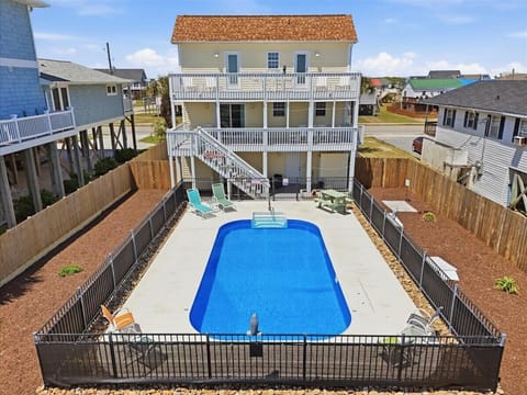 Elevated beach house features a private pool with multi decks and outdoor lounging space.
