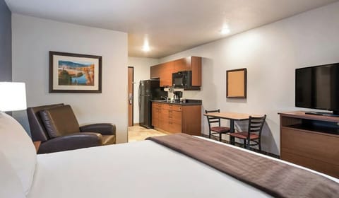 Unwind in your cozy suite with kitchenette and lounge chair.
