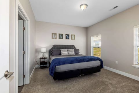 Spacious master bedroom featuring a comfortable king-size bed designed for a restful night’s sleep.