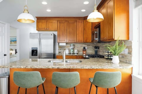 The kitchen boasts a modern design with stainless steel appliances, granite countertops, and a view that makes cooking a delight.