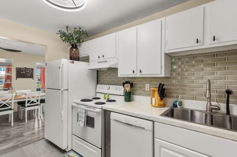 Kitchen with full-size appliances and modern backsplash