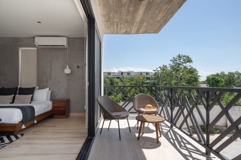 Private balcony with modern seating and tranquil tropical views.