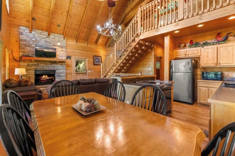Spacious dining area with rustic wood table, perfect for family meals.
